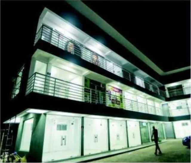 Lake Plaza at night, lit shopfronts along the upper gallery, Lekki